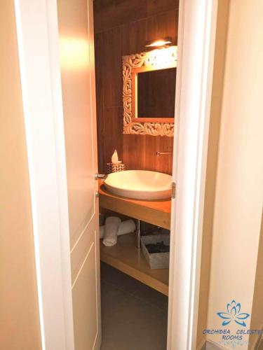 a bathroom with a tub and a sink with a mirror at B&B Orchidea Celeste in Manfredonia