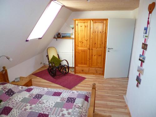 a bedroom with a bed and a wooden door at Nordseerex in Ahrenshöft