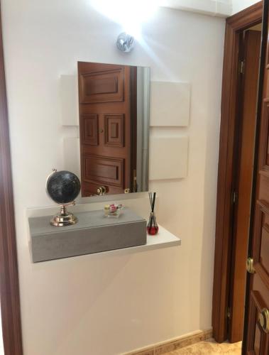 a bathroom with a mirror and a shelf on the wall at Beta's place - Apartamento primera línea de playa in Blanes