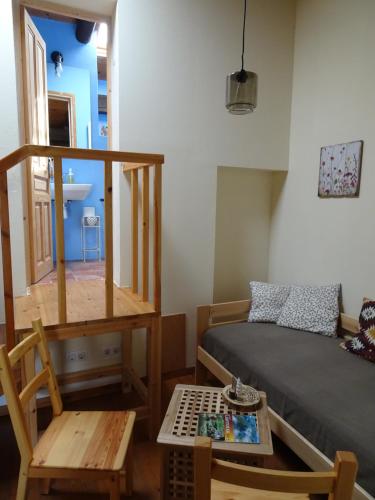 a room with a bed and a table and a chair at Les Magranes Bed & Breakfast in Argelaguer