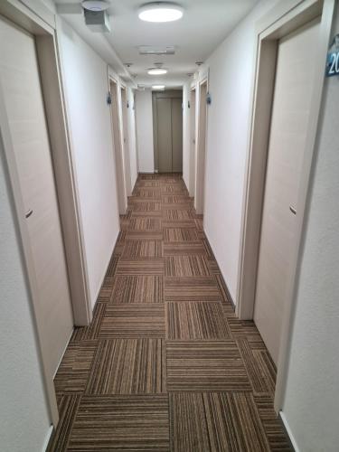 a corridor of an office building with a long hallway at Helvetia in Seewen