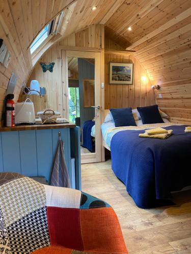 a bedroom with two beds in a wooden cabin at Broad Croft House in Horton in Ribblesdale