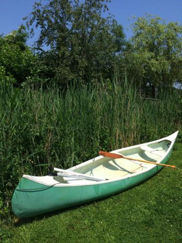 a green and white boat sitting on the grass at Gipsy wagon near Amsterdam and beach in Velserbroek 