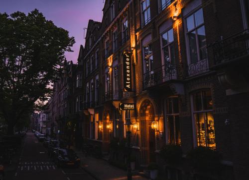 a street with a building with lights on it at Hotel Alexander in Amsterdam