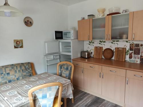 a kitchen with a table and a table and chairs at Ferienwohnung mit Terrasse für 1-4 Personen in Altena