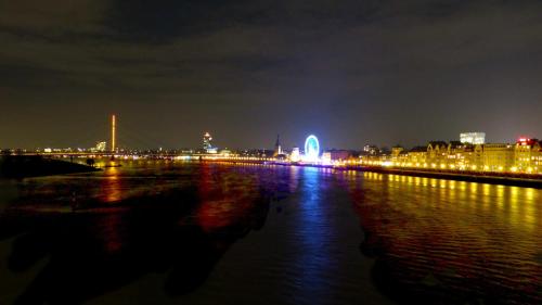 a view of a city at night with a river at Hotel Wurms in Düsseldorf