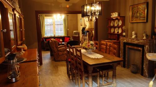 a living room with a table and a fireplace at Julienne5 in Blégny