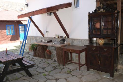 a kitchen with a wooden desk and a wooden table at Casa de vacanta traditionala romaneasca in Schiuleşti