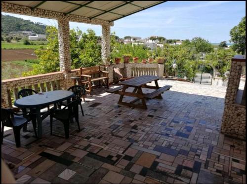 a patio with tables and chairs on a brick patio at casa dei limoni in Peschici