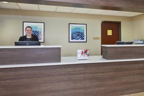 a man sitting at a counter in a hospital lobby at Candlewood Suites Grand Rapids Airport by IHG in Grand Rapids
