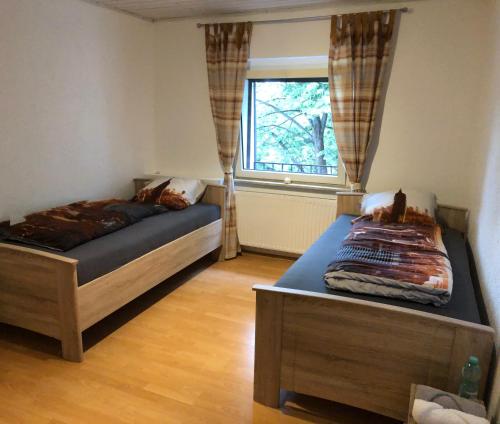 a bedroom with two beds and a window at M/P in Duisburg