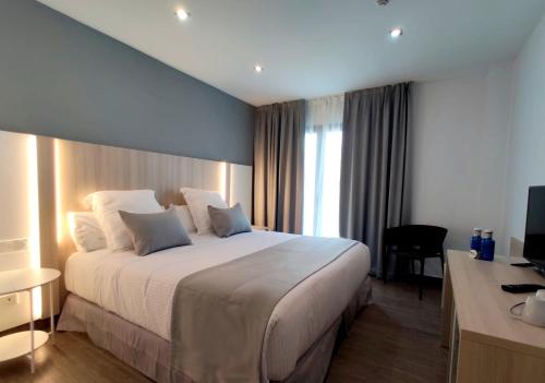 a hotel room with a large bed and a large window at Soul Beach Hotel By Mc- Adults only in Denia