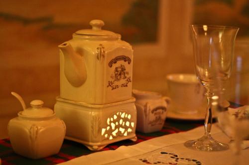 a table with a tea pot and a glass at Vila Terrasse in Košice