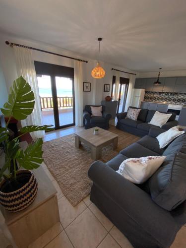 a living room with a couch and a table at Sea View Villa Anastasia in Ierissos