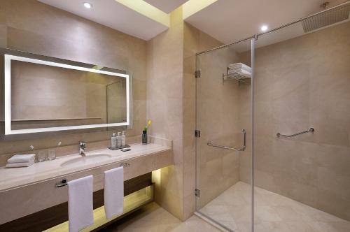 a bathroom with a sink and a shower at voco Al Khobar by IHG in Al Khobar
