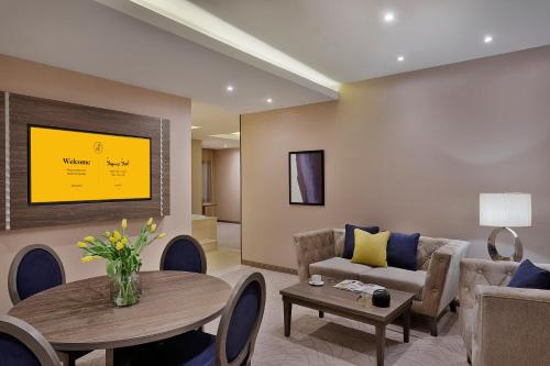 a living room with a couch and a table at voco Al Khobar by IHG in Al Khobar