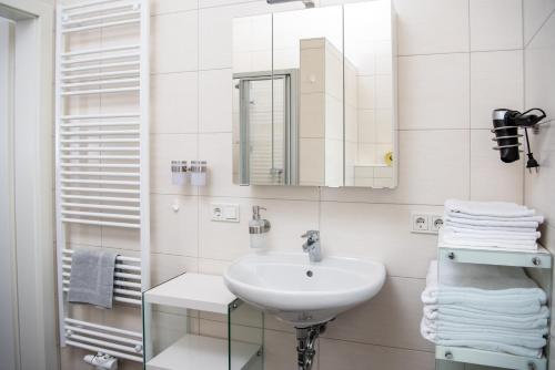 a white bathroom with a sink and a mirror at Ferienhaus Prasl in Jagerberg