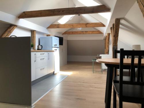 a kitchen with white appliances and a table in a room at Joyful Apartments Sopot in Sopot