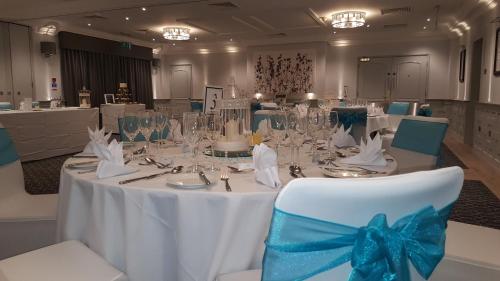 a table with a blue bow on top of it at voco Oxford Spires by IHG in Oxford