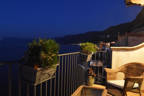 a balcony with a table and chairs and a view of the water at B&B La Veduta in Scilla