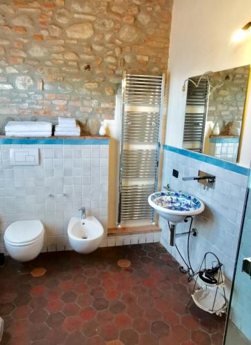 a bathroom with a white toilet and a sink at Angolo Del Poeta in Bergamo