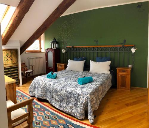 a bedroom with a bed with blue pillows on it at ESPERIA casa vacanza in Trieste
