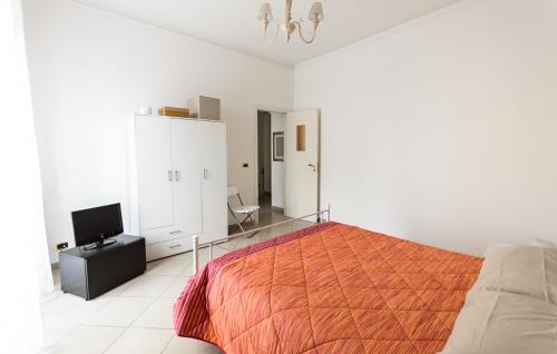 a white bedroom with a bed and a television at casa ilaria manfredonia in Manfredonia