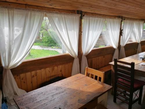 a dining room with a table and a window at Pivovar Špitt Zahořany in Litoměřice