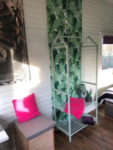 a room with two pink chairs and a mirror at Dunez men only resort in Drunen