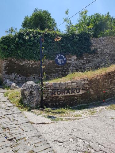 a brick wall with a sign on it at Konaku Guest house in Gjirokastër
