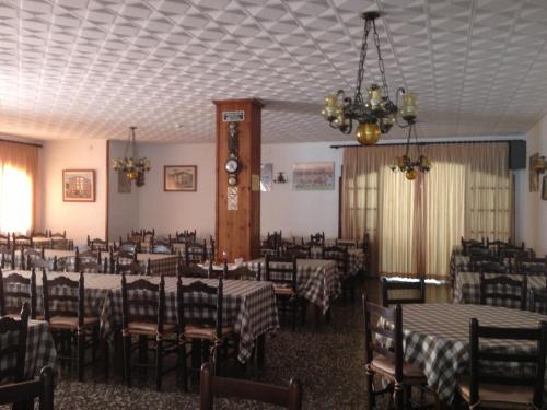 a dining room with tables and chairs and a chandelier at Raco d'en Pepe in Calella