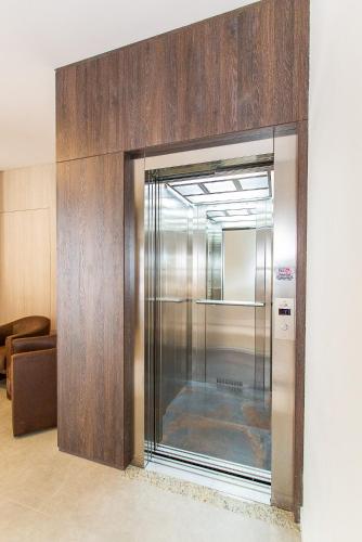 a stainless steel refrigerator in a room at LENA ROSA Premium Hotel in Pomerode