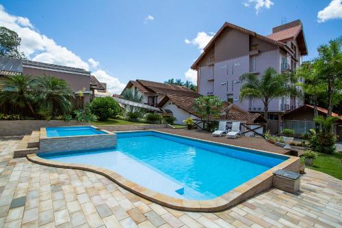 a swimming pool in the backyard of a house at LENA ROSA Premium Hotel in Pomerode