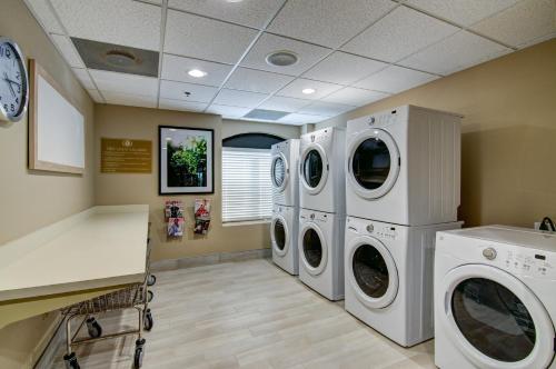 a laundry room with two washer and dryer at Candlewood Suites Richmond - West Broad by IHG in Richmond