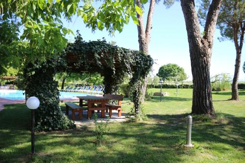 a picnic table in a park next to a tree at Podere San Paolo in San Giuliano Terme