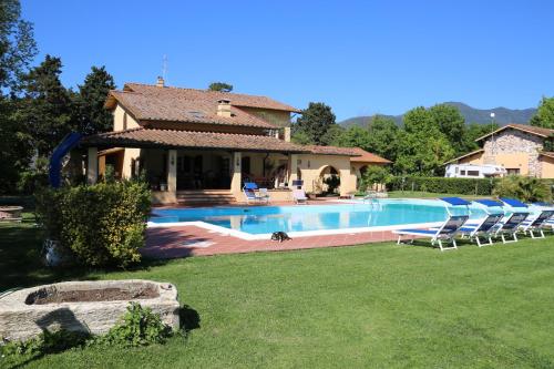 a house with a swimming pool in a yard at Podere San Paolo in San Giuliano Terme