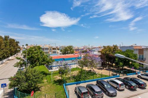 a row of cars parked in a parking lot at Cabanas Beach Penthouse in Cabanas de Tavira