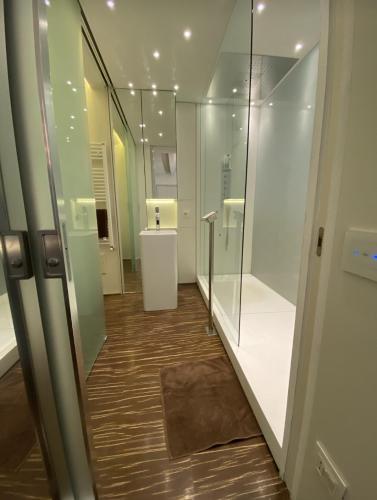 a hallway with glass walls and wooden floors in a building at Welcome Traveller ATMOSPHERE APARTMENT in Bardolino