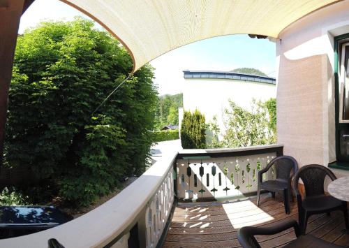 a balcony with chairs and a table and a bridge at Apartment Haus Braumandl in Bad Ischl