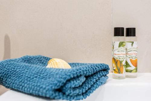 a blue towel sitting next to a bottle of cleaner at Mariners (2) - Bright and stylish apartment - walk to the beach in Luz
