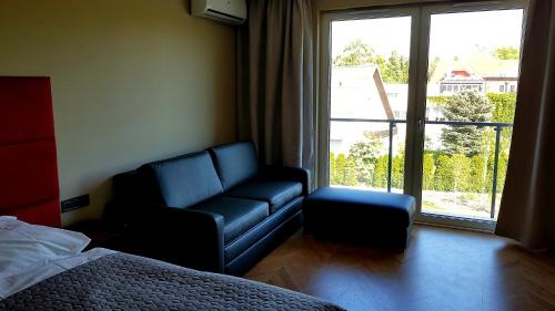um quarto com uma cama, uma cadeira e uma janela em Apartament Wrocław Marina nad Odrą 29 em Breslávia