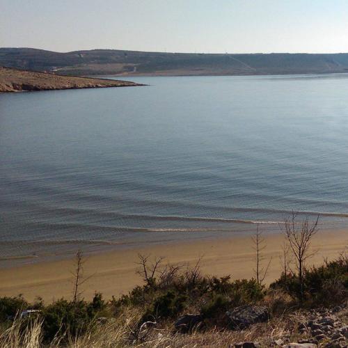 a view of a beach next to a body of water at Apartman Salvia in Starigrad-Paklenica