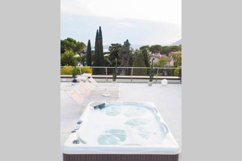 a hot tub sitting on top of a patio at Luna27 in Toscolano Maderno
