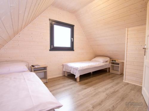 Ένα ή περισσότερα κρεβάτια σε δωμάτιο στο Słoneczna Przystań