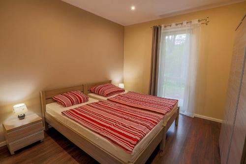 a bedroom with a bed with two pillows and a window at LouisaPark in Łagów