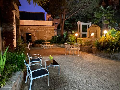 a patio with chairs and a table and a building at Turismo Homes Solar Do Areal in Braga