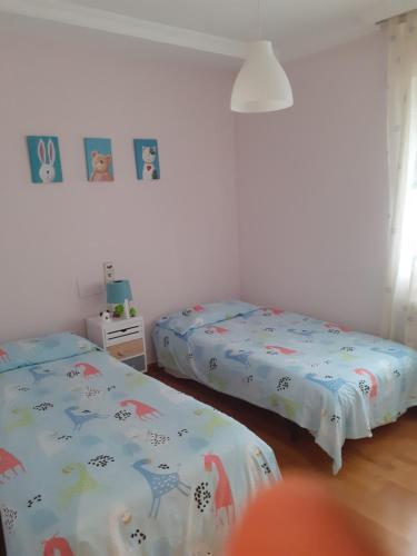 two beds in a room with two beds sidx sidx sidx at Apartamento Nuit in Teruel