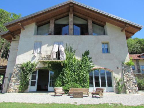 a building with benches in front of it at Le Maddalene B&B in Avigliana