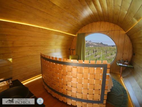 a round room with a round window in a wooden room at Pacheca The Wine House Hotel e Spa - Quinta da Pacheca in Lamego