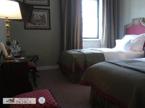 a hotel room with two beds and a window at Pacheca The Wine House Hotel e Spa - Quinta da Pacheca in Lamego